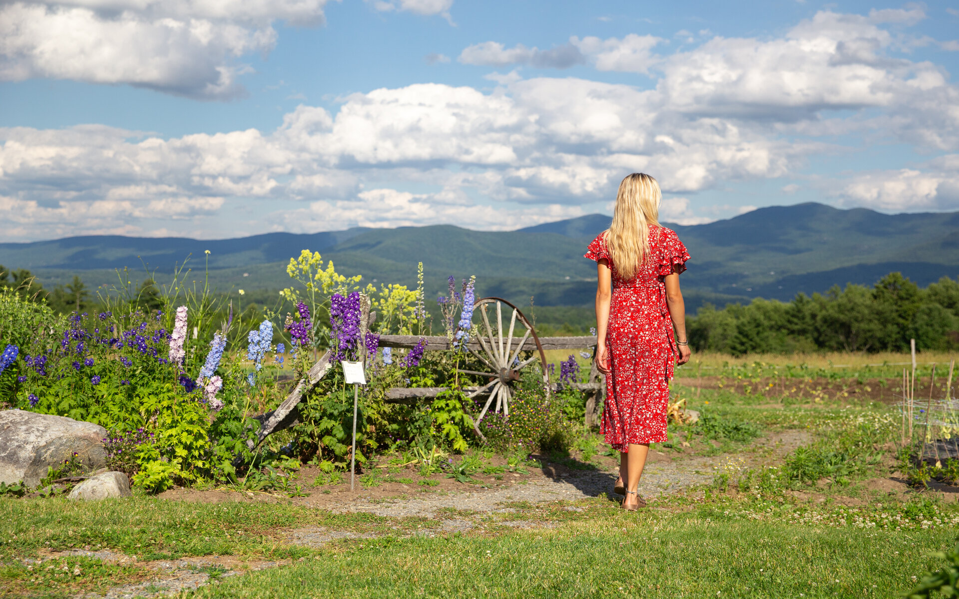 woman walking near flowers at our Stowe mountain resort