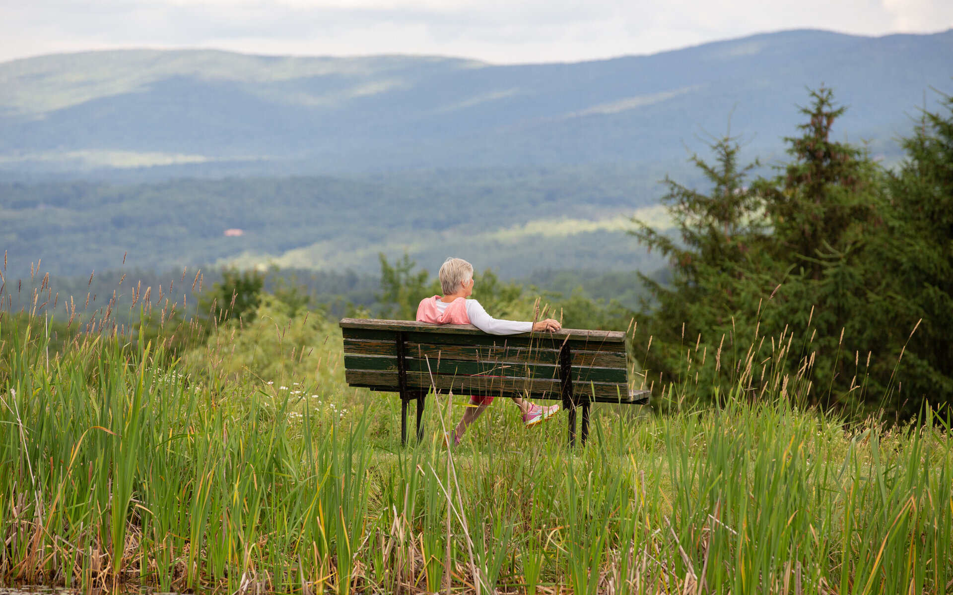 Person on bench looking at mountains